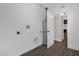Utility room featuring a water heater, washer dryer hookups, and hardwood floors at 719 Se 24Th St, Ocala, FL 34471