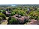 Drone shot of the property within a sprawling community with lakes and trees at 7230 Westpointe Blvd # 1222, Orlando, FL 32835