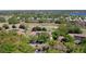 Overhead view of home nestled in a tree-lined community adjacent to the golf course at 7230 Westpointe Blvd # 1222, Orlando, FL 32835