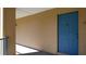 Exterior hallway featuring unit 12 with a blue door in a well-maintained building at 7230 Westpointe Blvd # 1222, Orlando, FL 32835