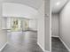 Bright, open-concept living room showcasing wood floors and natural light from the sliding glass doors at 7230 Westpointe Blvd # 1222, Orlando, FL 32835