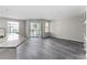Open living space featuring wood flooring, natural light, and granite countertops at 7230 Westpointe Blvd # 1222, Orlando, FL 32835