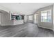 Open living area featuring wood flooring and a view of the kitchen and balcony at 7230 Westpointe Blvd # 1222, Orlando, FL 32835