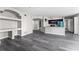 Spacious living room with a view of the kitchen and bathroom, featuring modern wood floors at 7230 Westpointe Blvd # 1222, Orlando, FL 32835