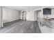 Living room featuring custom built-ins, wood flooring, and a view of the modern kitchen at 7230 Westpointe Blvd # 1222, Orlando, FL 32835