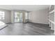 Bright living room featuring wood floors, sliding glass doors to a balcony, and neutral walls at 7230 Westpointe Blvd # 1222, Orlando, FL 32835