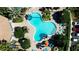 Aerial view of a community pool with lounge chairs and tropical landscaping at 7230 Westpointe Blvd # 1222, Orlando, FL 32835