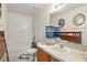 Bathroom with white vanity, white toilet, combination tub and shower at 750 Sterling Spring Rd, Orlando, FL 32828