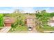 Charming two-story home with a well-manicured front lawn and mature trees at 750 Sterling Spring Rd, Orlando, FL 32828
