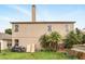 Rear exterior of two-story home with lush backyard and chimney at 750 Sterling Spring Rd, Orlando, FL 32828