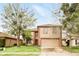 Charming two-story home with a two-car garage, well-maintained lawn, and mature trees offering shade at 750 Sterling Spring Rd, Orlando, FL 32828