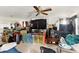 Open living area with a ceiling fan, tiled floors, a large TV and colorful ' enclosure at 750 Sterling Spring Rd, Orlando, FL 32828