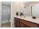 Bathroom featuring wooden cabinetry, tile flooring, a large mirror, and a walk-in shower at 778 Gainer Way, Winter Springs, FL 32708
