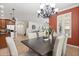 Bright dining room with tile floors, modern cabinets, and decorative light fixture at 778 Gainer Way, Winter Springs, FL 32708