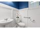 Stylish half bathroom with a pedestal sink, modern fixtures, and elegant wainscoting at 778 Gainer Way, Winter Springs, FL 32708