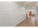 Hallway with shiplap accent wall leading to the dining room at 778 Gainer Way, Winter Springs, FL 32708