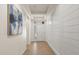 Bright hallway features a shiplap accent wall and neutral tile flooring, illuminated by recessed lighting at 778 Gainer Way, Winter Springs, FL 32708