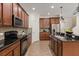 Kitchen with granite countertops, tile backsplash, stainless steel appliances, and tile floors at 778 Gainer Way, Winter Springs, FL 32708