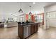 Open kitchen features granite countertops, stainless steel appliances, and a view of the living and dining areas at 778 Gainer Way, Winter Springs, FL 32708