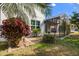 Charming screened patio surrounded by lush landscaping and a beautiful garden with a bird bath at 778 Gainer Way, Winter Springs, FL 32708
