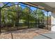 Expansive screened patio featuring brick flooring and tranquil view of the landscaped backyard at 778 Gainer Way, Winter Springs, FL 32708