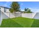 Spacious backyard with lush green grass and a privacy fence, perfect for outdoor activities at 808 Grandin St, Davenport, FL 33837