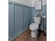 Charming half bath with stylish blue wainscoting and wood-look tile floor at 808 Grandin St, Davenport, FL 33837
