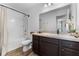Bathroom with a vanity and cabinet, a shower-tub combo, and modern fixtures creating a sleek design at 808 Grandin St, Davenport, FL 33837