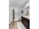 Bright bathroom with a shower-tub combo, wooden vanity and cabinet, and essential decor at 808 Grandin St, Davenport, FL 33837