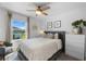 Cozy bedroom boasts natural light, a ceiling fan, and tasteful decor creating a serene retreat at 808 Grandin St, Davenport, FL 33837