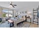 Comfortable bedroom with window view, decor and seating including decorative ladder at 808 Grandin St, Davenport, FL 33837