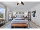 Bright bedroom features a ceiling fan, area rug, and a bed with a wooden bench at the foot at 808 Grandin St, Davenport, FL 33837