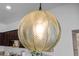 Stylish glass globe chandelier hangs above the kitchen island, adding a modern touch at 808 Grandin St, Davenport, FL 33837