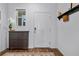 Welcoming entryway with dark wood floors, cabinet, and plenty of natural light at 808 Grandin St, Davenport, FL 33837
