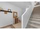 Bright hallway with decorative shelf, cabinet, mirror, and staircase at 808 Grandin St, Davenport, FL 33837