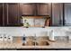 Granite countertops and dark cabinets add sophistication to this lovely kitchen at 808 Grandin St, Davenport, FL 33837