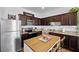 Well-equipped kitchen with dark cabinets, stainless steel appliances, and a stylish island at 808 Grandin St, Davenport, FL 33837