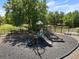 Community playground with multiple slides, blacktop base and bordered by black metal fencing at 808 Grandin St, Davenport, FL 33837