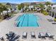 Stunning aerial view of the community pool with lounge chairs, landscaping, and pristine water at 808 Grandin St, Davenport, FL 33837