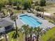 Aerial view of a community pool surrounded by palm trees and lounge chairs, perfect for relaxation at 808 Grandin St, Davenport, FL 33837