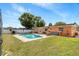 Backyard featuring a private pool, fenced yard, patio with tables and green grass at 825 Keats Ave, Orlando, FL 32809