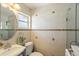 Stylish bathroom featuring tiled walls, modern fixtures, and a vanity at 825 Keats Ave, Orlando, FL 32809