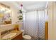 Bathroom featuring granite countertop, tile flooring, and bath/shower combo with patterned curtain at 825 Keats Ave, Orlando, FL 32809