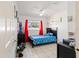 Bright bedroom with a themed comforter set, red curtains, and tile flooring at 825 Keats Ave, Orlando, FL 32809