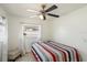 Bedroom featuring a ceiling fan, tile flooring, and window with white curtains at 825 Keats Ave, Orlando, FL 32809