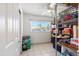 Storage area with tile flooring, shelving, a window with blinds, and ceiling fan at 825 Keats Ave, Orlando, FL 32809