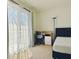 Carpeted bedroom with sliding doors to a balcony with sheer curtains, a workstation, and a closet at 827 Dennis Ave, Orlando, FL 32807