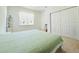 Bright bedroom with ample natural light, featuring a closet and neutral decor, offering a peaceful retreat at 827 Dennis Ave, Orlando, FL 32807