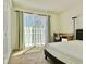 Bedroom featuring a sliding door to a balcony with sheer curtains, a workstation, and a closet at 827 Dennis Ave, Orlando, FL 32807