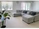 Cozy living room with plush sectional sofa and large windows, offering comfortable living at 827 Dennis Ave, Orlando, FL 32807